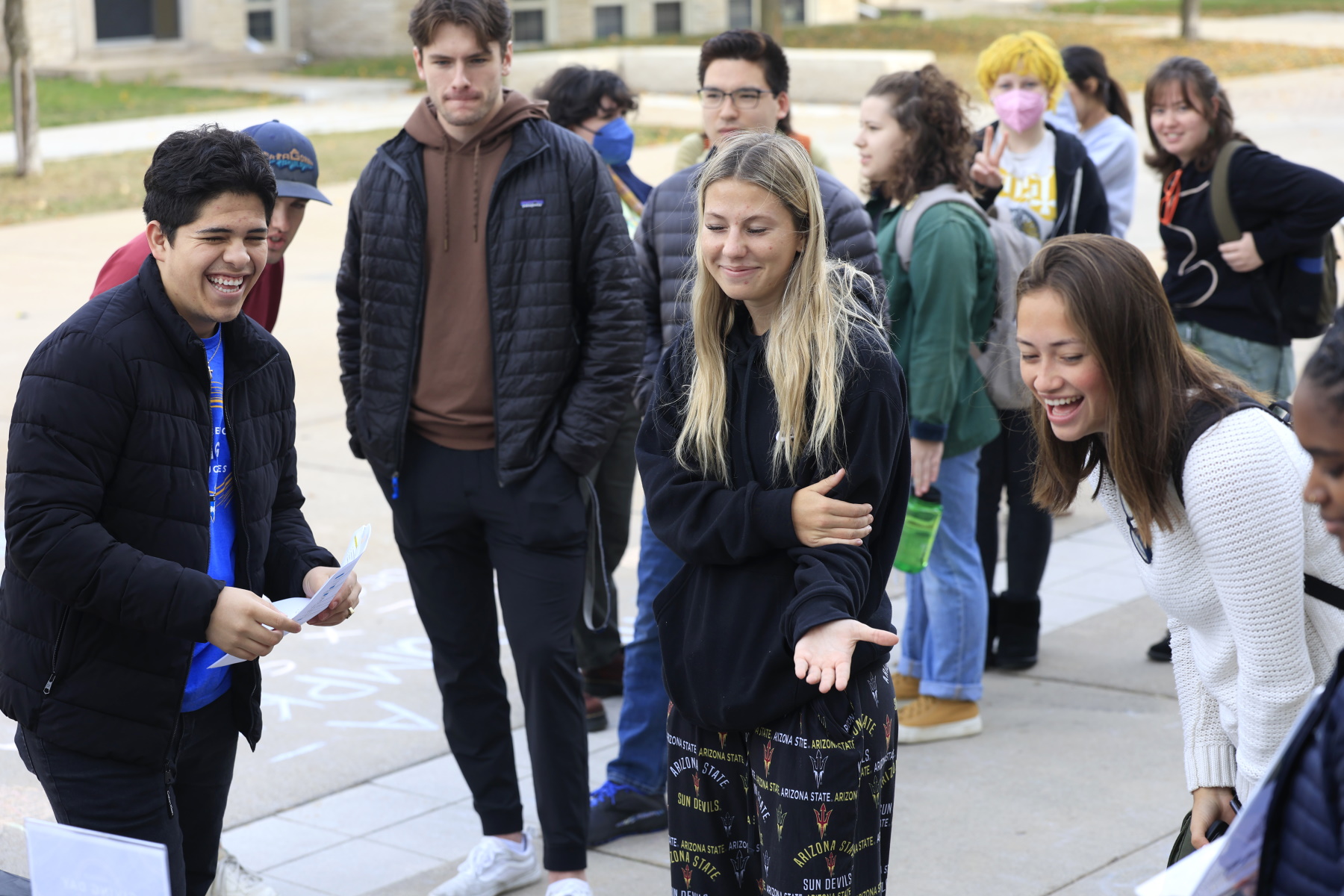 Students line up to play Spin the Wheel in front of Warch Campus Center.