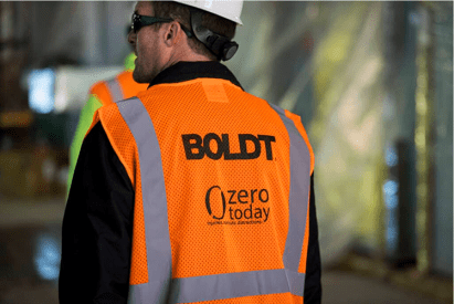 Boldt Zero Today worker with safety glasses, hi-viz vest, and hardhat.