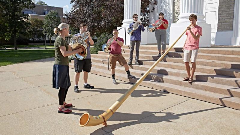Students and faculty play horns on Memorial Chapel steps